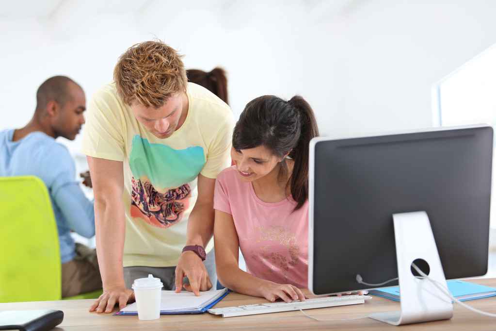 Gyakornokok egy számítógép előtt dolgoznak